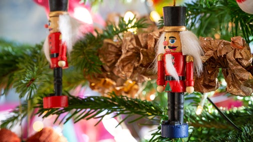 Nutcracker decorations hanging on Christmas tree